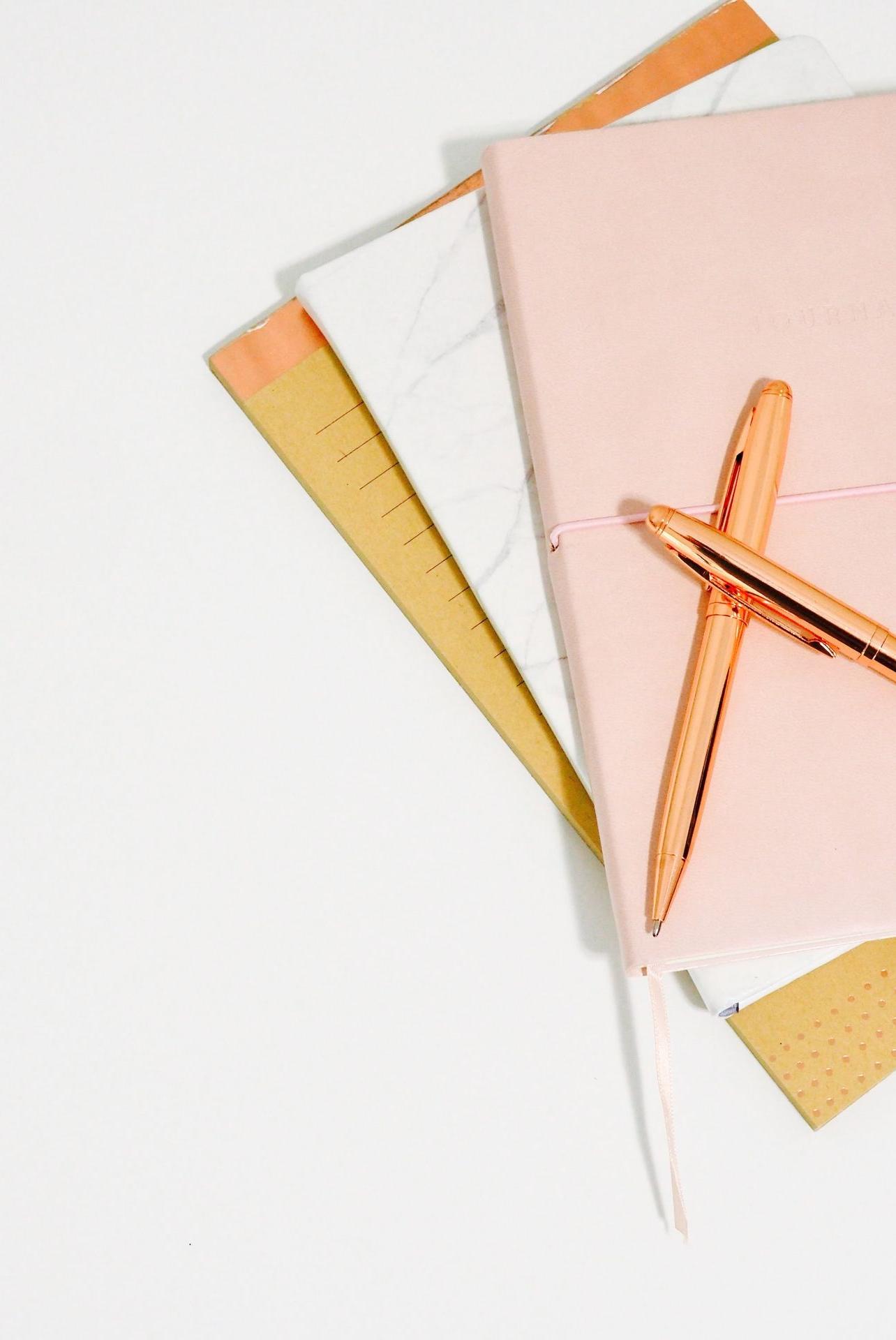 ballpoint pens on pink notebook
